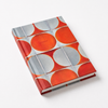 Notebook with orange and gray circular pattern on a white background
