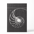 A hardcover notebook with a dark textured cover featuring a white nautilus shell spiral design, shown on a clean white background.
