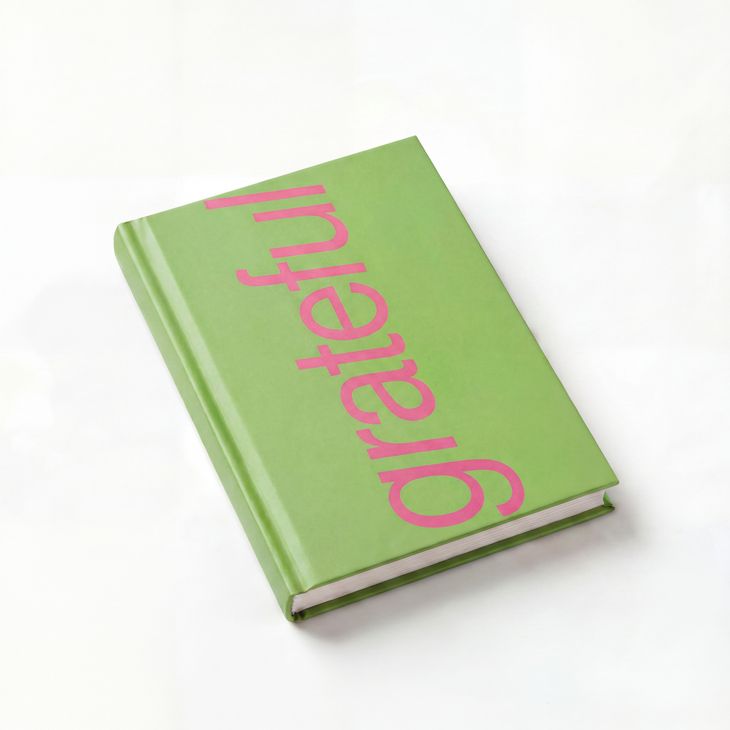 Green book with pink 'grateful' text on a white background