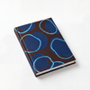 Journal with blue circular pattern on a white background