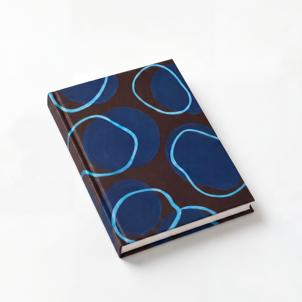 Journal with blue circular pattern on a white background