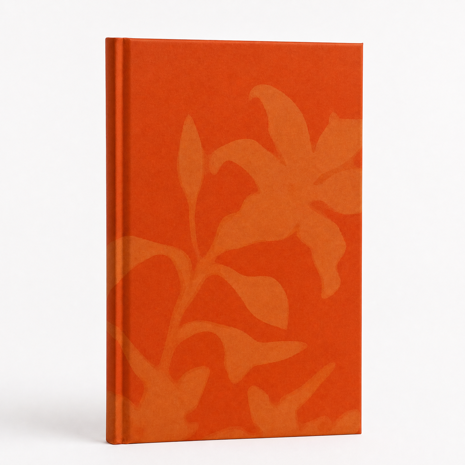Orange notebook with floral pattern on a white background